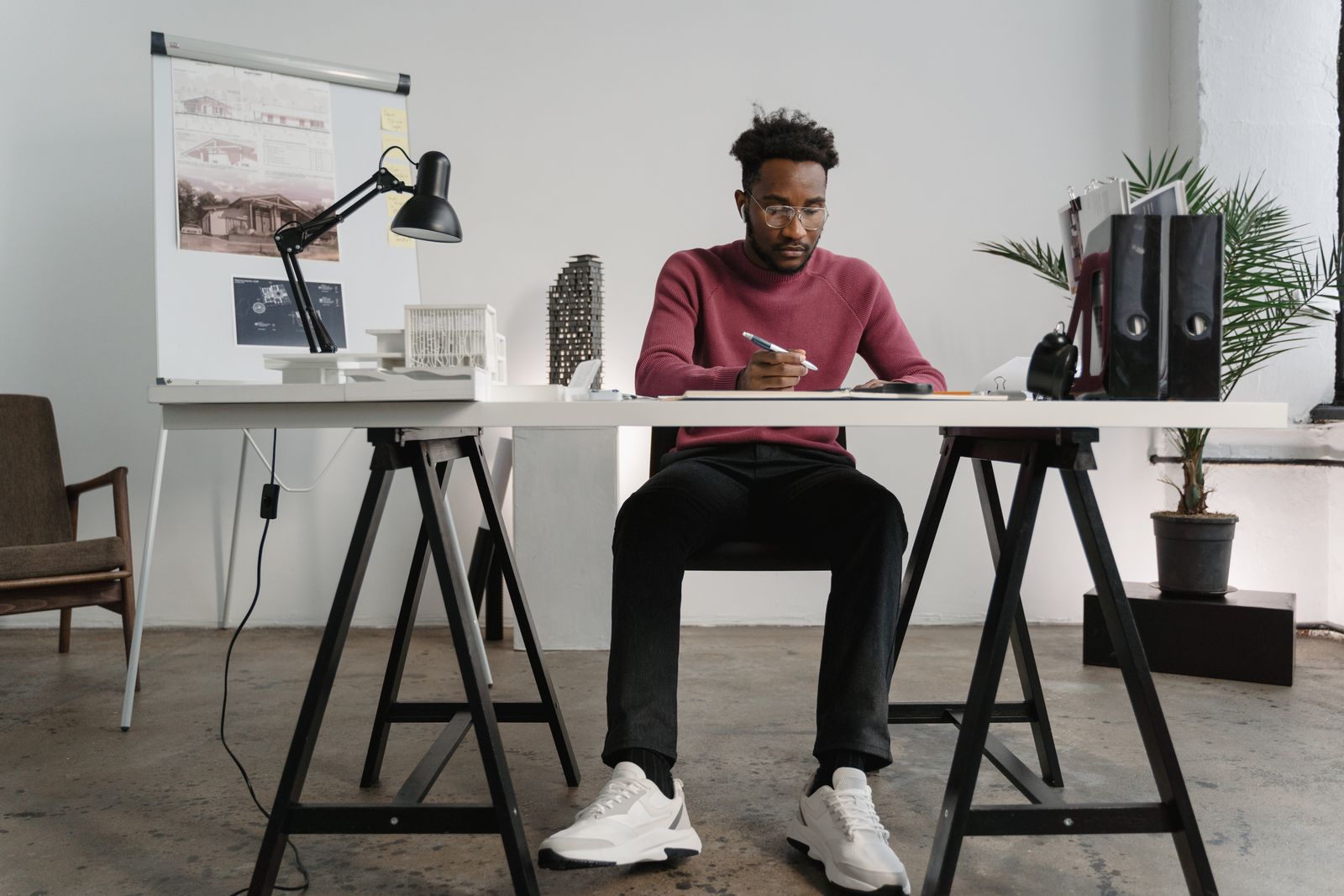 Creative professional working at a desk in a bright design studio